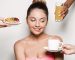 Spa accessories wellness setting with cosmetic bottles and salt with white plumeria flower, blurred massage stones in wooden bowl in background, spa concept, copy space
